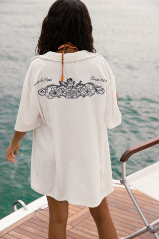 Men's elevated and comfortable terry towel button up. Going out top or beach top, good for holidays. White terry towel fabric button up, detailed navy embroidery across the back