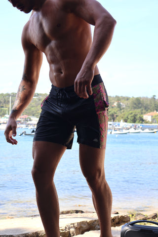 4-way stretch, quick dry black boardies/swimshorts. Fun pink hibiscus and leopard print pattern down the side panels, black boardies